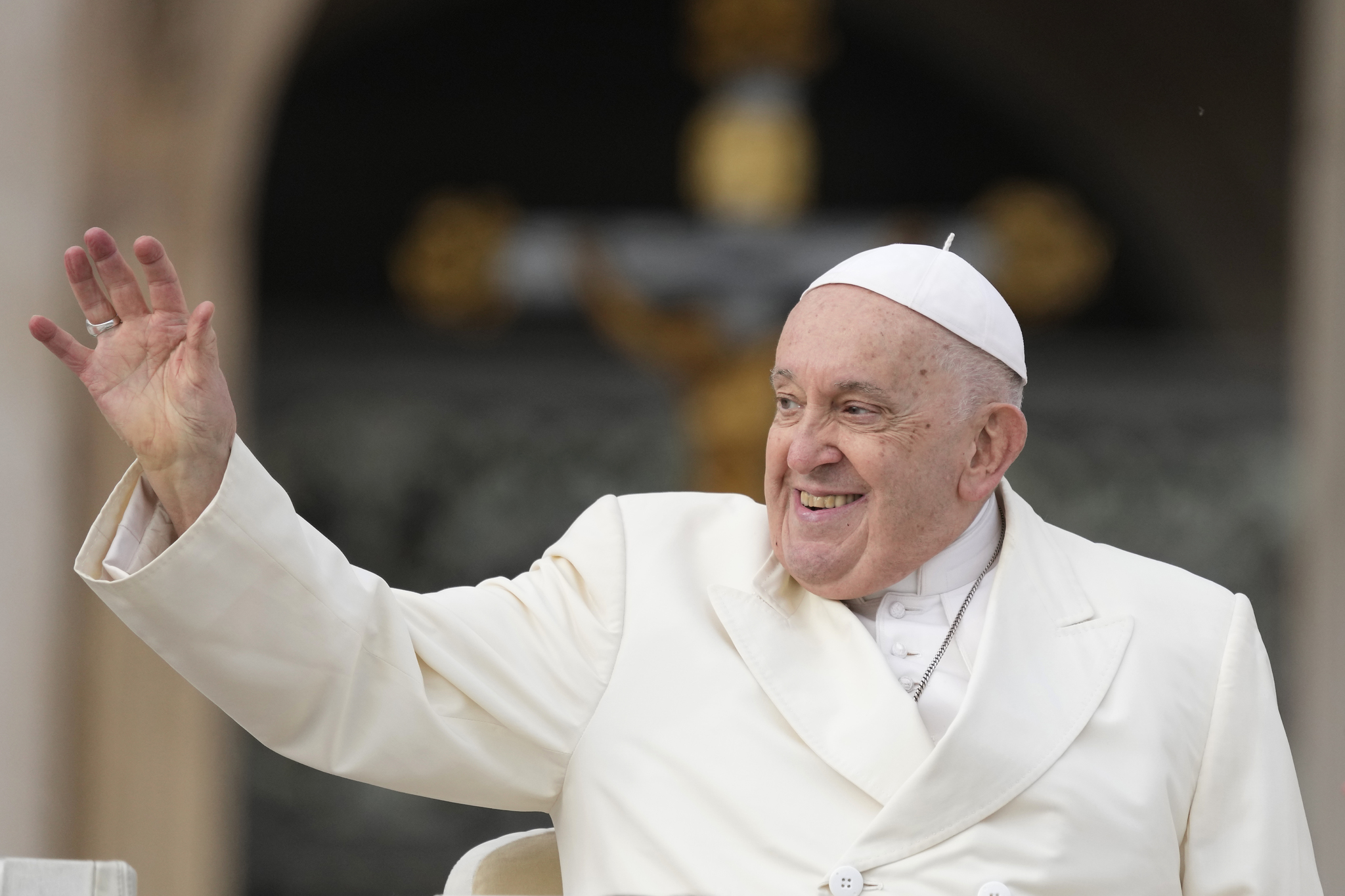 Pope Francis smiles as he waves